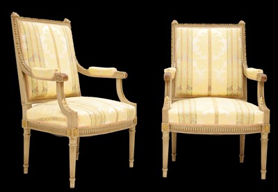 Lot 501 - Pair of French Louis XVI-style painted and parcel-gilt fauteuils or open armchairs