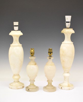 Lot 695 - Two pairs of white onyx lamp bases