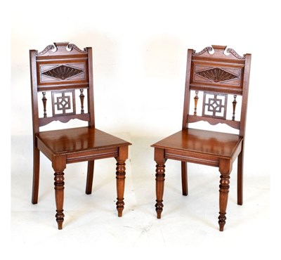 Lot 425 - Two late Victorian or Edwardian walnut hall chairs