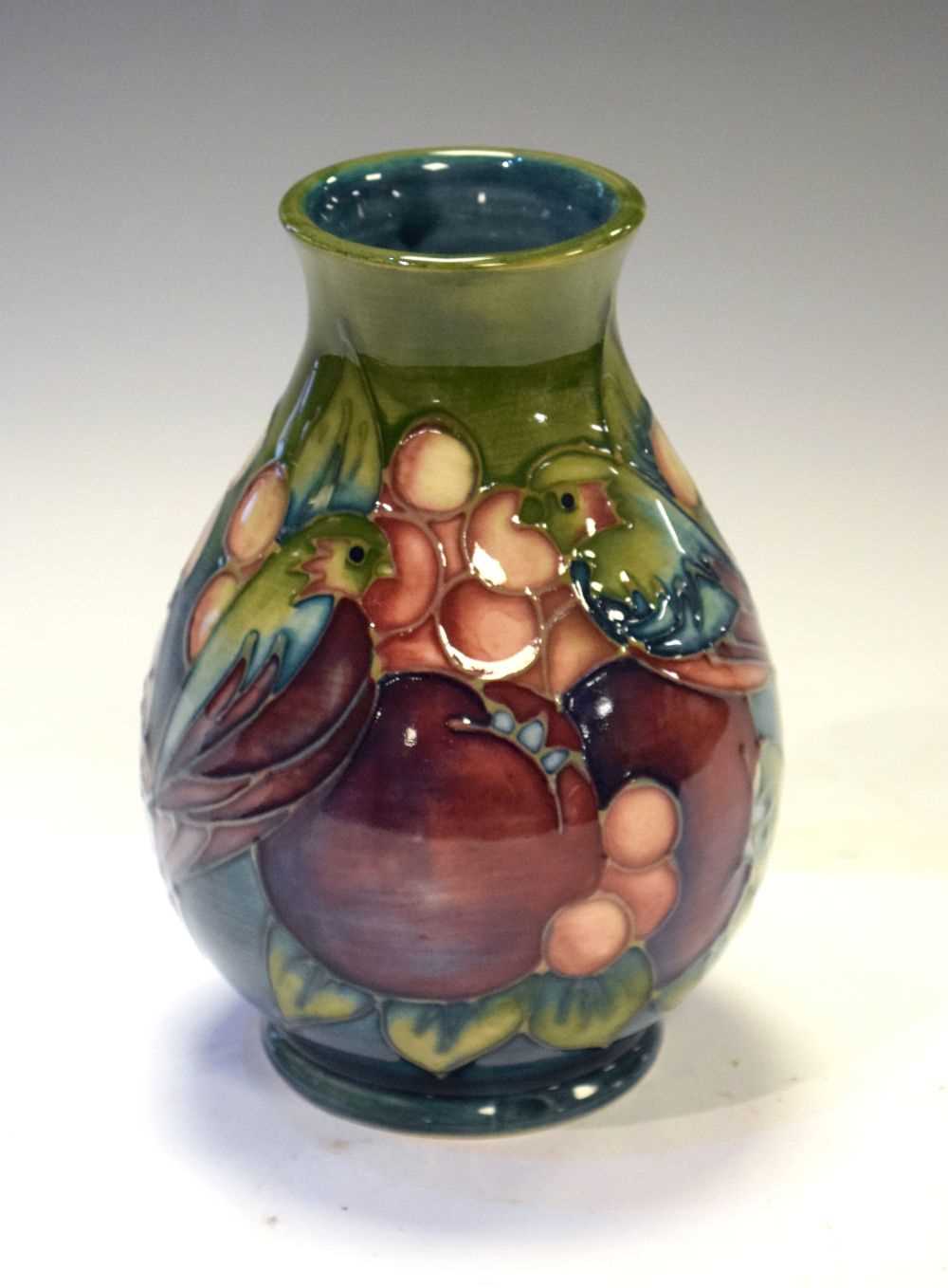 Lot 218 - Moorcroft - 'Finches' pattern baluster vase tube lined with pomegranate, berries and birds