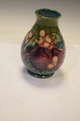 Lot 218 - Moorcroft - 'Finches' pattern baluster vase tube lined with pomegranate, berries and birds