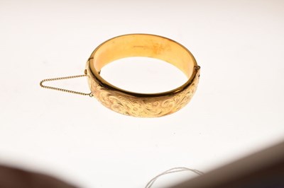 Lot 65 - 9ct gold half engraved hinged bangle