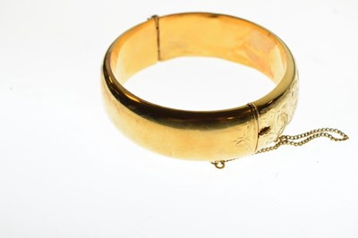 Lot 65 - 9ct gold half engraved hinged bangle