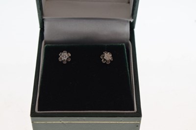 Lot 75 - Pair of 9ct white gold diamond single stone ear studs