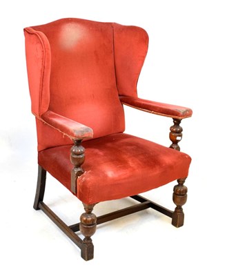 Lot 459 - Early 20th Century oak framed red upholstered wing back chair