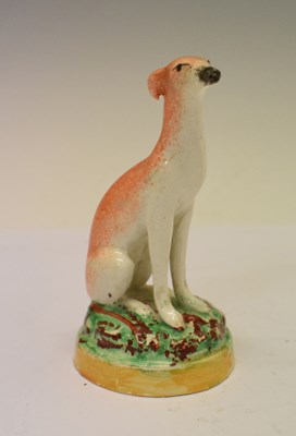 Lot 166 - Victorian Staffordshire pottery model of a seated greyhound