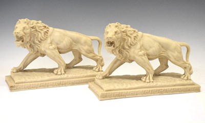 Lot 599 - Pair of resin lions in walking position