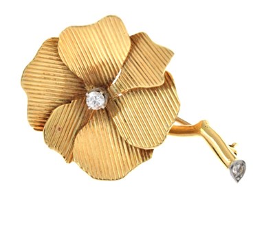 Lot 100 - 18ct gold diamond set stylised flower brooch