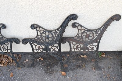 Lot 754 - Two pairs of cast metal garden bench ends having side circular Lion head motifs