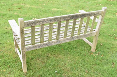 Lot 752 - Teak two seater garden bench of slatted design