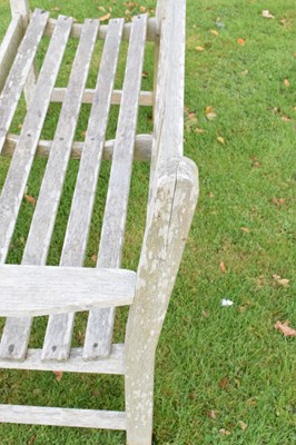 Lot 752 - Teak two seater garden bench of slatted design