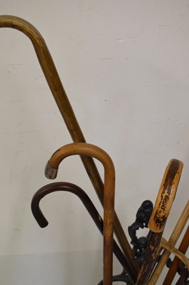 Lot 686 - Cast metal stick stand with assorted sticks