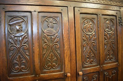 Lot 731 - Reproduction heavily carved oak two-door wardrobe