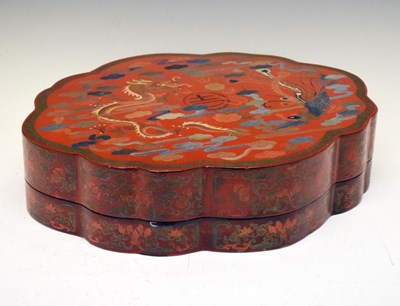 Lot 215 - Chinese red lacquer box of oval shaped form with dragon decoration