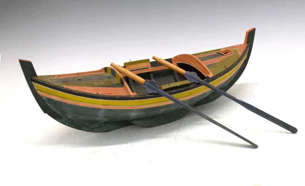 Lot 237 - Painted model boat, with rudder and oars