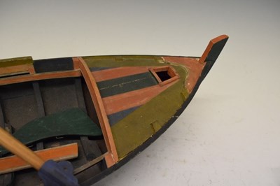Lot 237 - Painted model boat, with rudder and oars