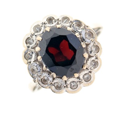Lot 25 - Yellow metal, garnet and white stone cluster ring