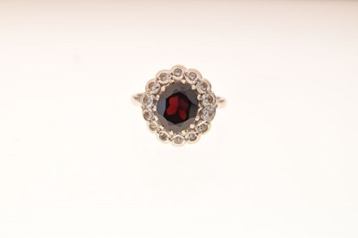 Lot 25 - Yellow metal, garnet and white stone cluster ring