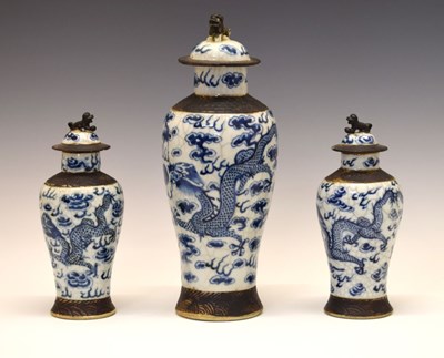 Lot 276 - Garniture of three Chinese porcelain crackleware baluster jars and covers