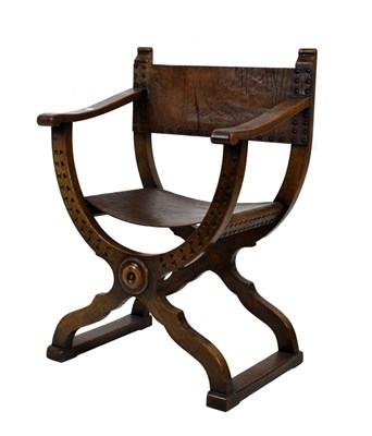 Lot 554 - Early 20th Century oak X-frame chair with leather seat and back