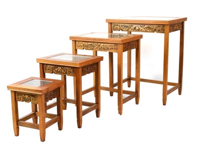 Lot 578 - Nest of four Chinese style tables, each top having carved decoration