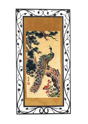 Lot 550 - Chinese textile panel decorated with a peacock set with in a foliate metal frame