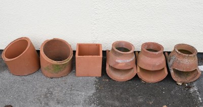 Lot 784 - Quantity of terracotta chimney tops, grown toppers, etc