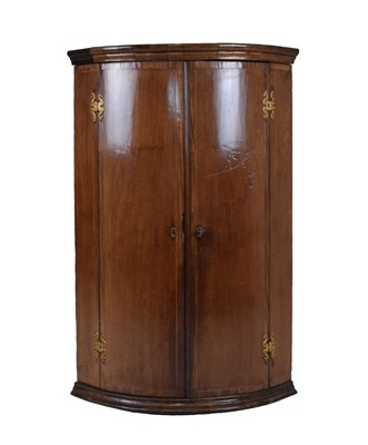 Lot 582 - George III bowfront corner cupboard