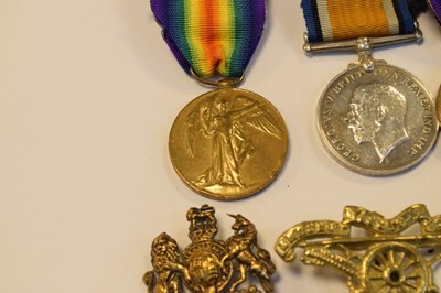 Lot 315 - Three First World War Medals and cap badges