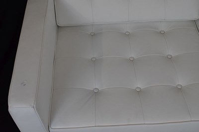 Lot 585 - White leather two-seater settee and footstool