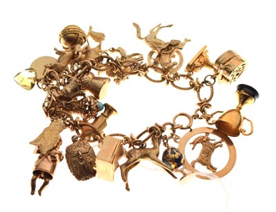 Lot 38 - 9ct gold charm bracelet, attached various charms