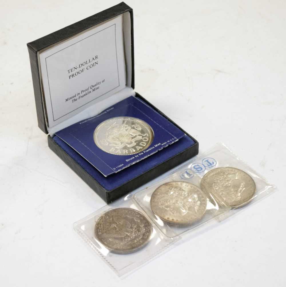 Lot 143 - Coins - Three silver American Dollars and a sterling Barbados ten dollar proof coin