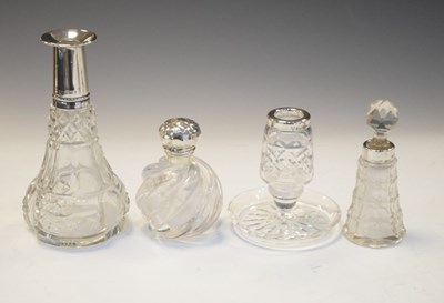 Lot 205 - Elizabeth II silver stamp moistener, three silver dressing table bottles and candle/pin stand